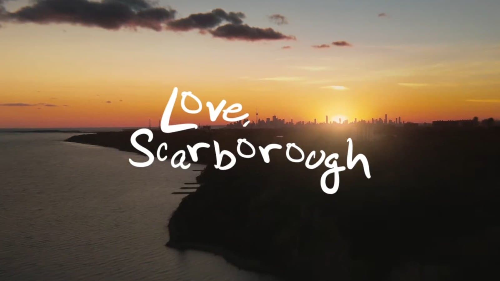 Title frame of the Love, Scarborough film: the words handwritten over a sunset on the Scarborough shore.